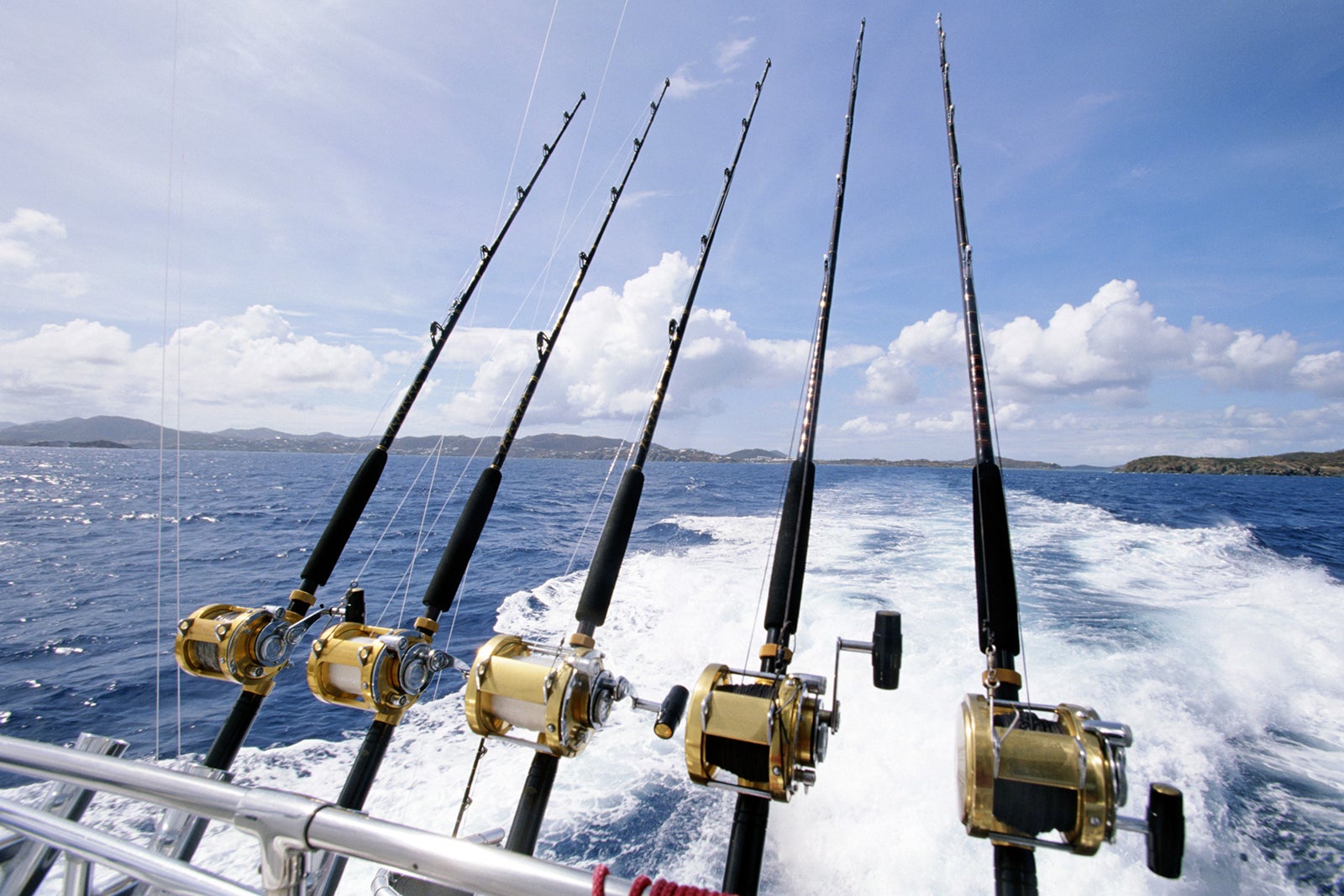 Blue water fishing in Indonesia. The blinker fish are ready for action.  When catching large predatory fish, they are pulled by the fishing rod  behind the fast moving boat. The True North