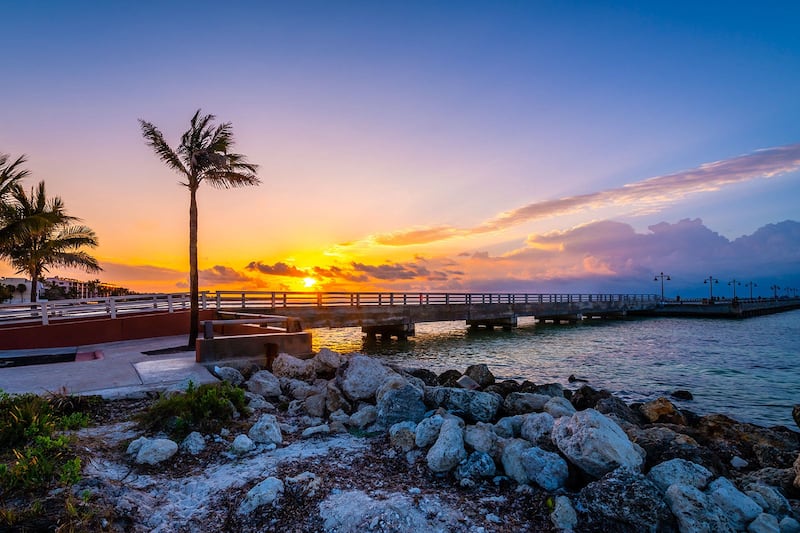 Key West beach with turquoise water and a sunset over the horizon