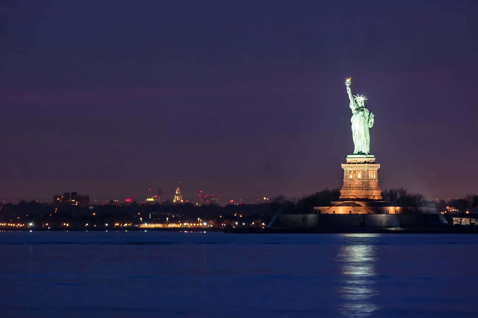 new york statue of liberty and city night